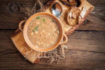 Mushroom soup on a wooden table.