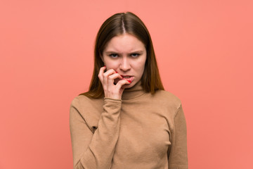 Young woman over colorful background nervous and scared