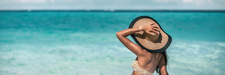 Beach suntan vacation woman relaxing wearing sun fashion floppy hat on ocean background panoramic...