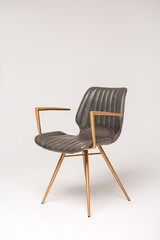 stylish grey armchair with wooden legs on a grey background