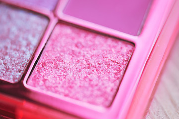 Pink glitter eye shadow closeup. Bright make up product.