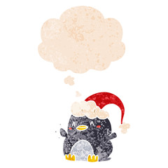cartoon penguin wearing christmas hat and thought bubble in retro textured style