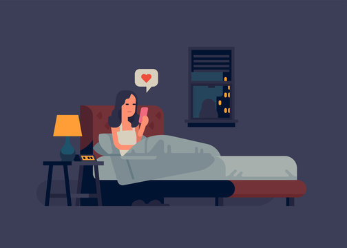 Woman Checking Her Phone In Bed