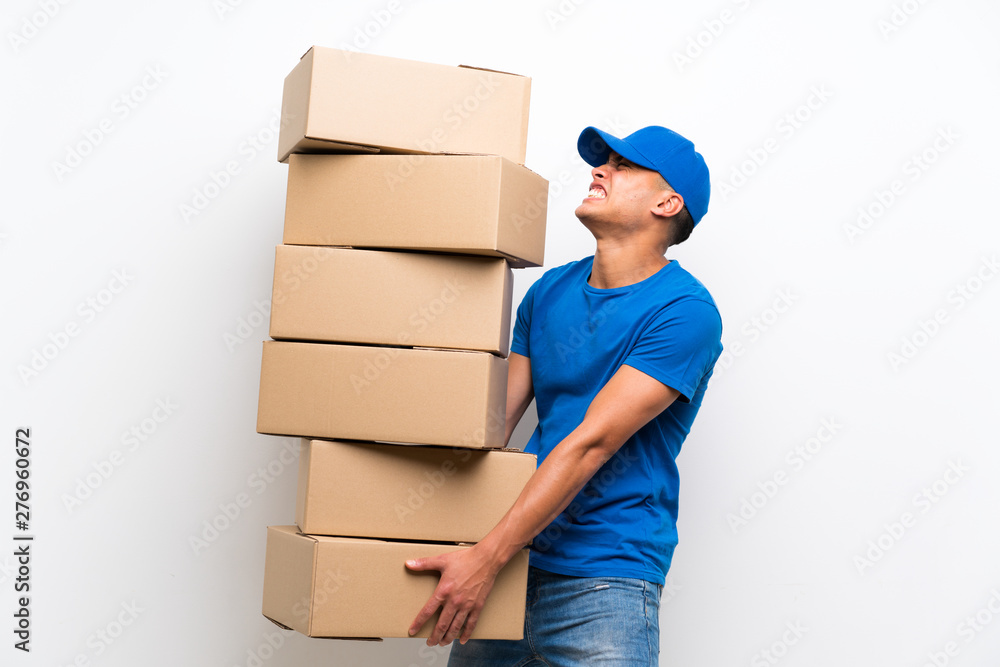 Wall mural Delivery man over isolated white wall