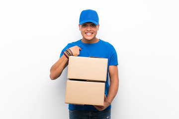 Delivery man over isolated white wall with surprise facial expression