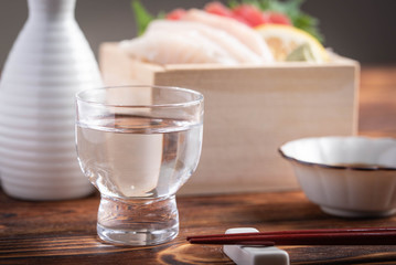 Obraz na płótnie Canvas japanese sake and sashimi in wooden box, masu