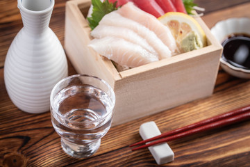 japanese sake and sashimi in wooden box, masu