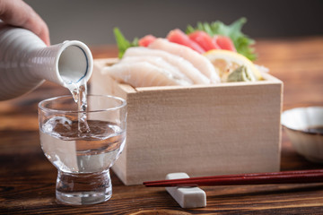 japanese sake and sashimi in wooden box, masu