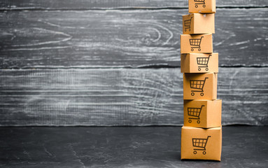 Tower of cardboard boxes with pattern of shopping carts. Purchasing power, delivery order. Sales of...
