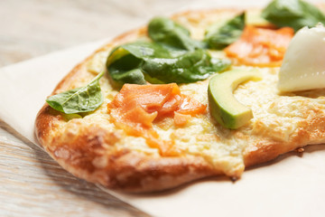 Baking, salmon pie and avocado on a light wooden background