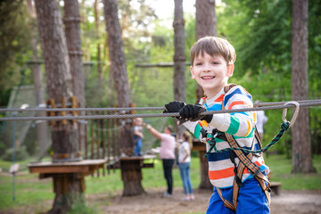 Cute child boy playing. Artworks depict games at eco resort which includes flying fox or spider...
