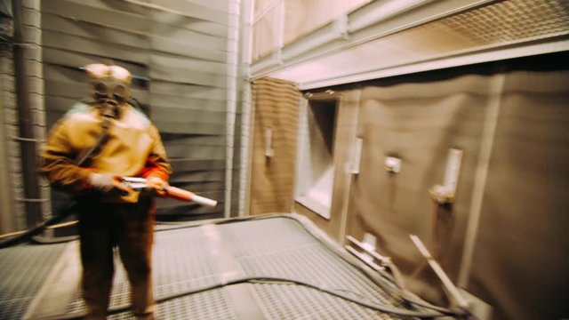 Worker in chemical rubber suit and respirator in chemical processing plant