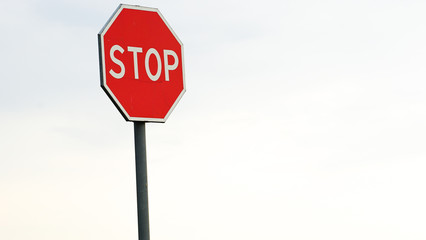 red stop sign, warning signs, over blue sunset sky.