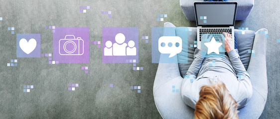 Social media with man using a laptop in a modern gray chair