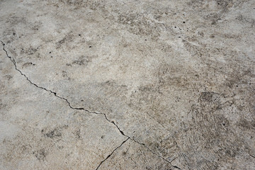The cement floor is not grey. There are cracks. Divide the cement into 3 parts unequal size. Texture or background.