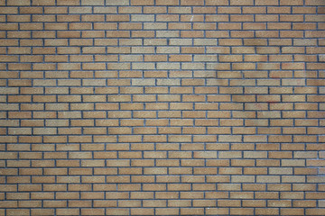 brick wall of gray and yellow bricks. rough surface texture