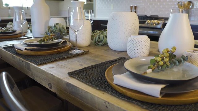 Dining Room Table Detail Move Right on Setting. view moves right on a close up of a place setting at a dining room table with kitchen in background