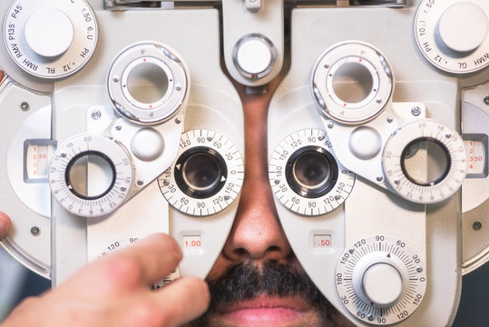  Patient in modern ophthalmology clinic checking the eye vision .
