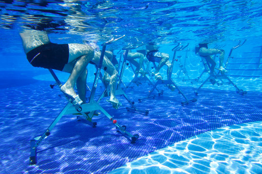 People involved in aqua aerobics on aquabikes in the pool