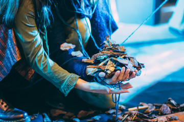 A ball of thread in a woman's hands.