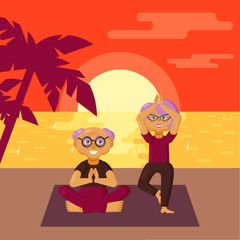 Cute older couple dressed in sports clothes practicing yoga exercises on the beach at sunset