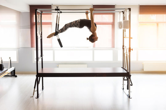 Pilates reformer workout exercises woman at gym indoor