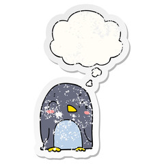 cartoon penguin and thought bubble as a distressed worn sticker