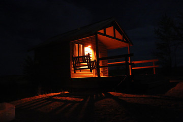 Warmly Lit Cabin at Night