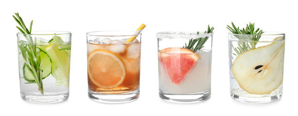 Set of glasses with different refreshing drinks on white background