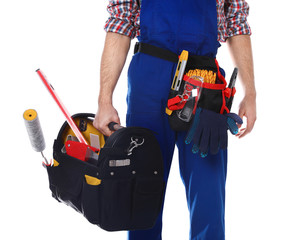Construction worker with set of tools on white background, closeup