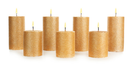 Stylish elegant gold candles on white background. Decor element