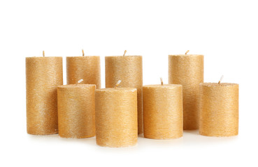 Stylish elegant gold candles on white background. Decor element