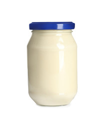 Delicious mayonnaise sauce in glass jar on white background