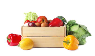 Wooden crate full of fresh products on white background