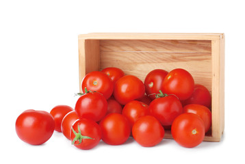 Overturned wooden crate with fresh ripe tomatoes on white background