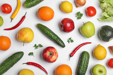 Flat lay composition with ripe fruits and vegetables on white background