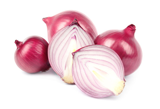 Fresh whole and cut red onions on white background