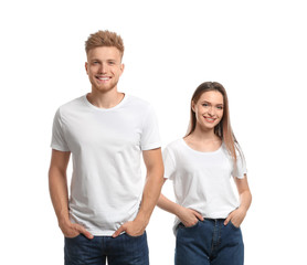 Young couple wearing blank t-shirts isolated on white. Mockup for design