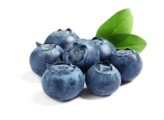 Fresh raw tasty blueberries with leaves isolated on white