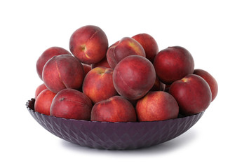 Bowl of delicious ripe peaches isolated on white