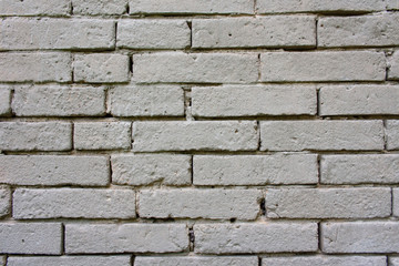 Obraz premium An old, damaged wall of gray bricks - a wabi-sabi style background