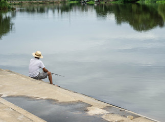 Man sitting fishing In the river