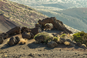 Natural stone arch of hardened lava near Mount of Igueque, sunset time. Teide National Park, Tenerife, Canary Islands, Spain
