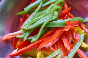 sliced organic green red and yellow peppers