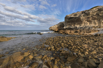 Fototapeta na wymiar Sandstone guards at the coastline of Arniston