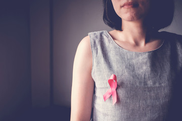 Asian women with pink ribbon, breast cancer awareness, October pink concept