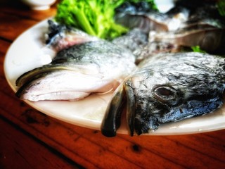 Fresh fish on a white tile plate