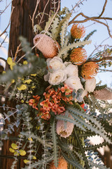 desert flower arrangement on an old post