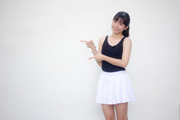 Portrait of thai adult beautiful girl black shirt white skirt pointing
