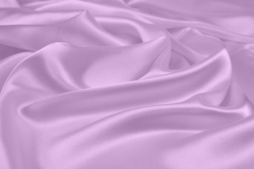 The texture of the satin fabric of lilac color for the background